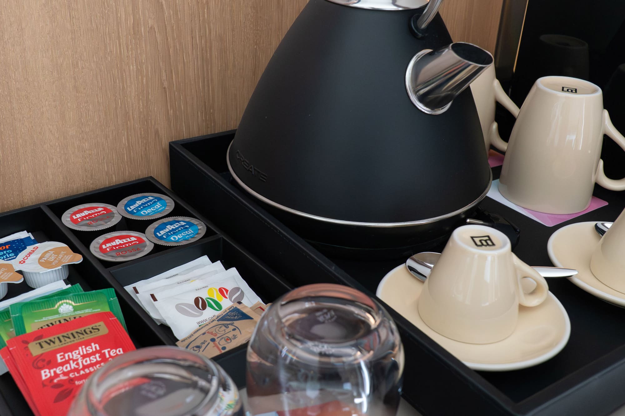 a tea kettle and cups on a tray