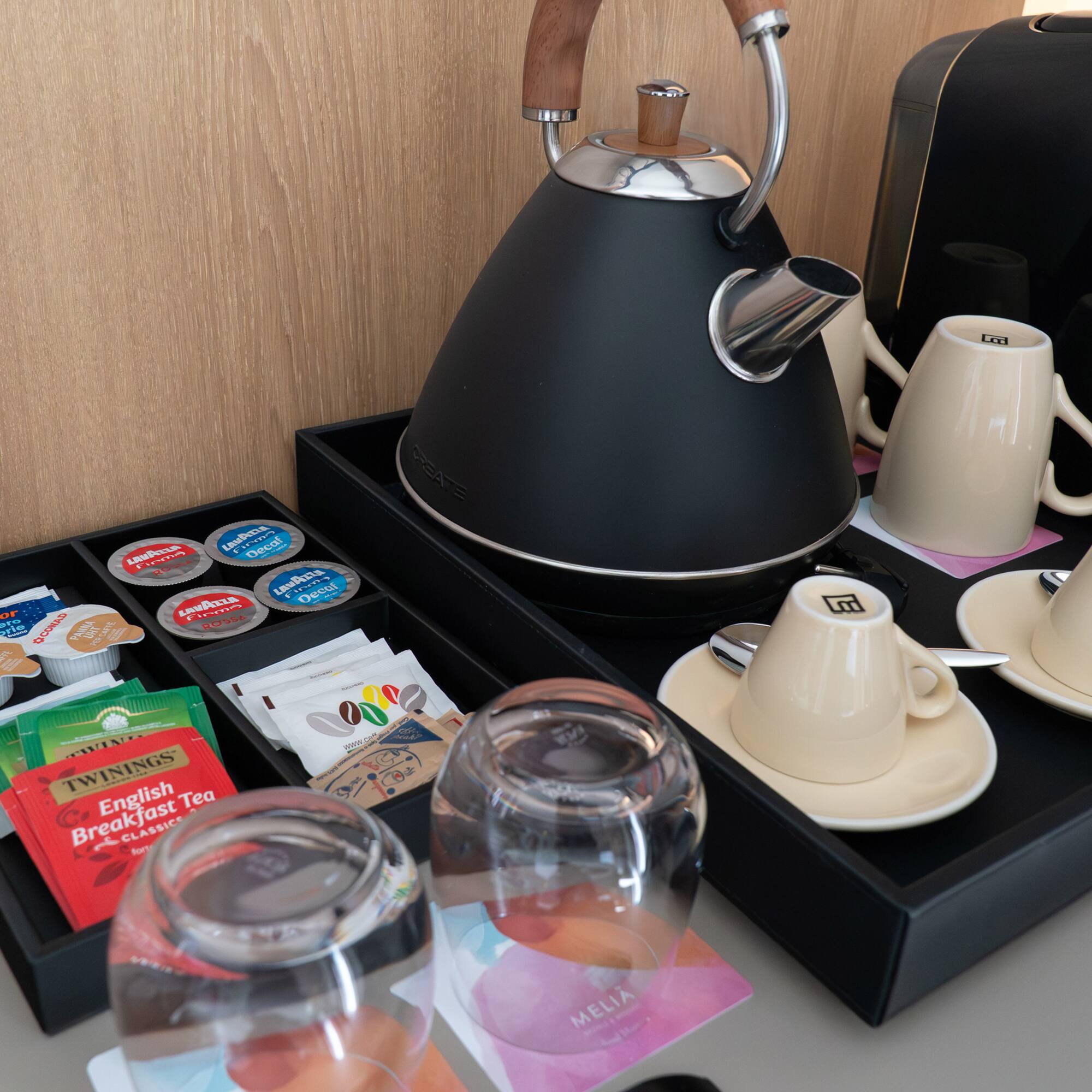 a tea kettle and cups on a tray