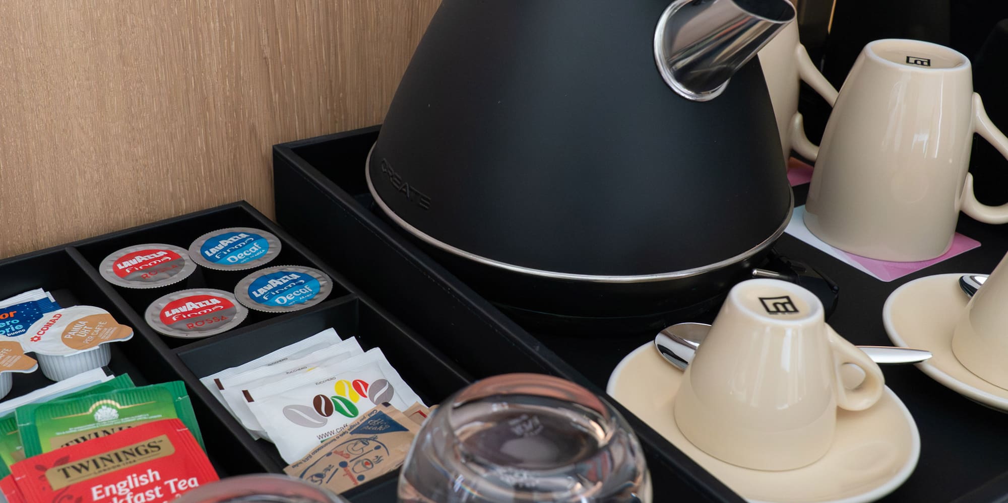 a tea kettle and cups on a tray