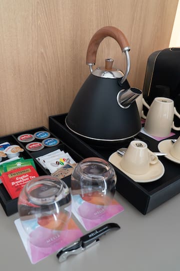 a tea kettle and cups on a tray