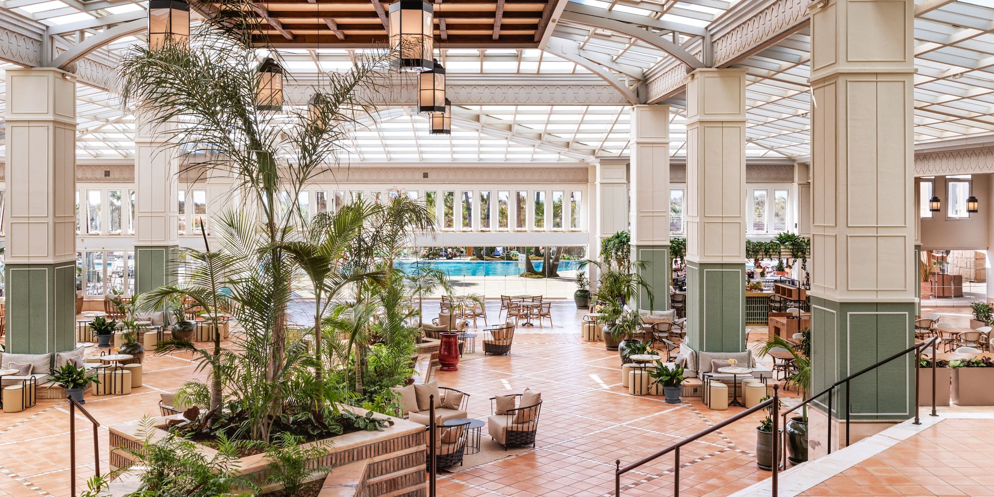 a large indoor pool with tables and chairs