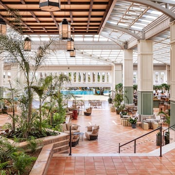 a large indoor pool with tables and chairs