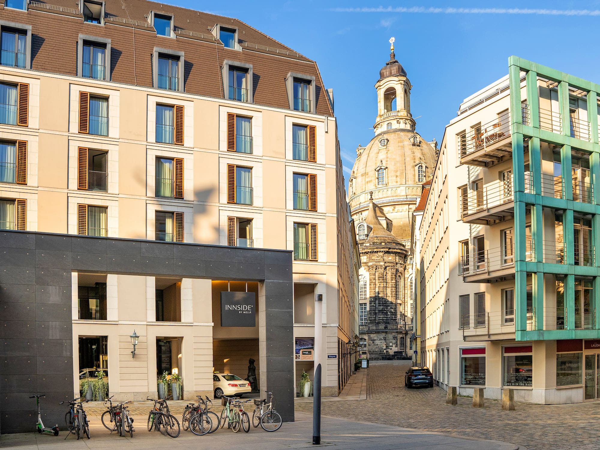 a street with bicycles parked in front of a building