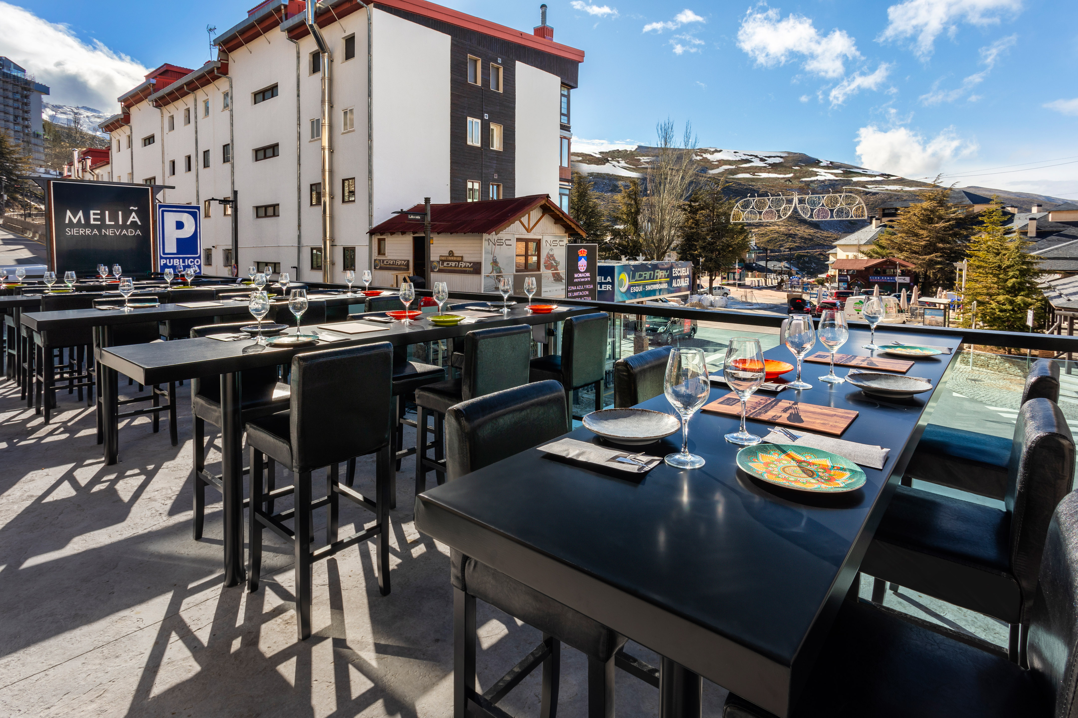 Meliá Sierra Nevada outdoor restaurant terrace, set tables, mountain view.