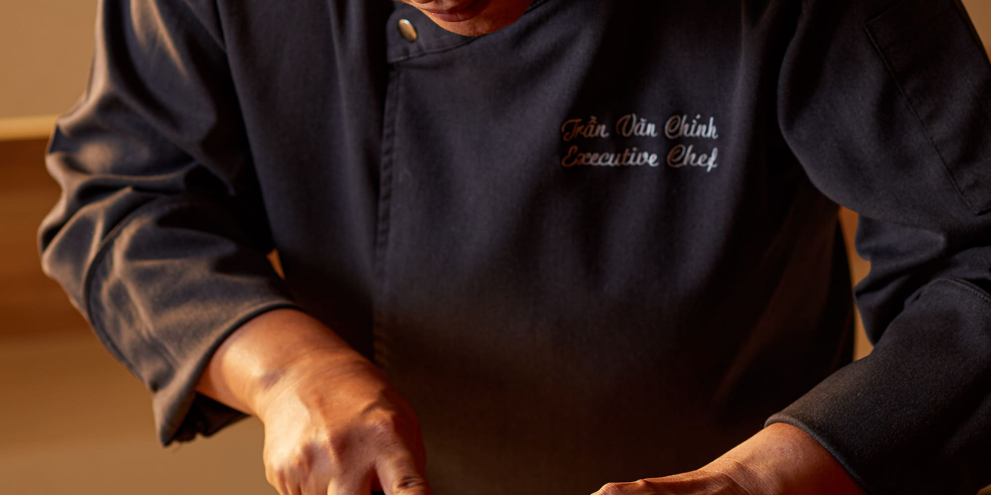 a man cutting fish on a cutting board