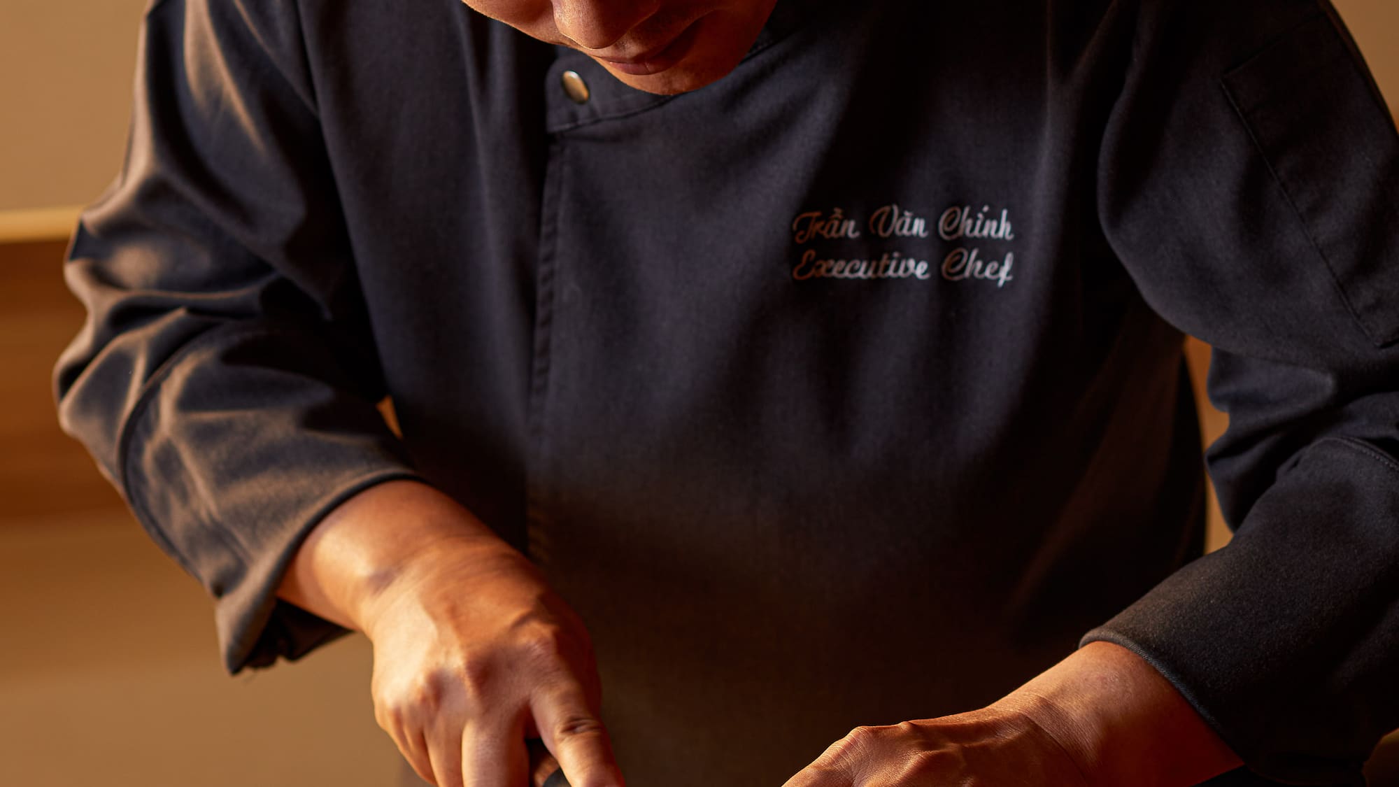 a man cutting fish on a cutting board