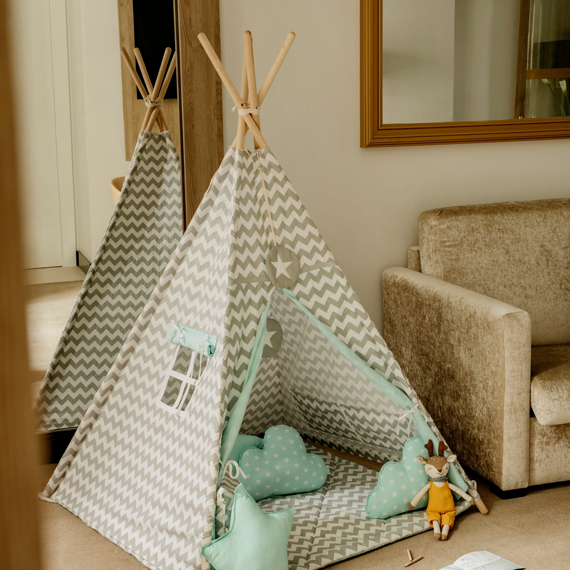 a teepee with pillows and toys