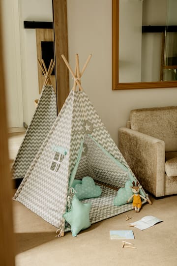 a teepee with pillows and toys