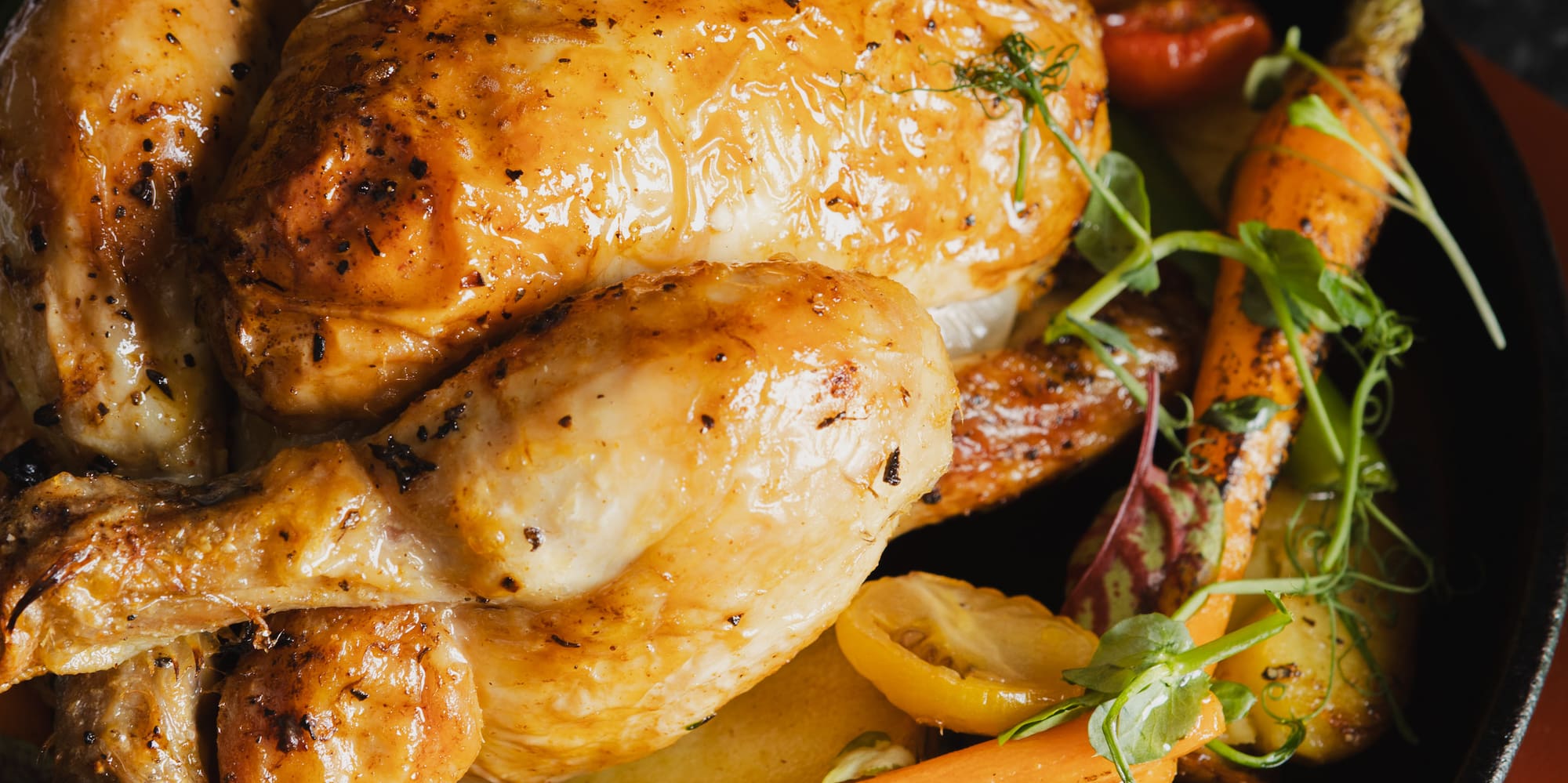 a pan of food with a chicken and vegetables