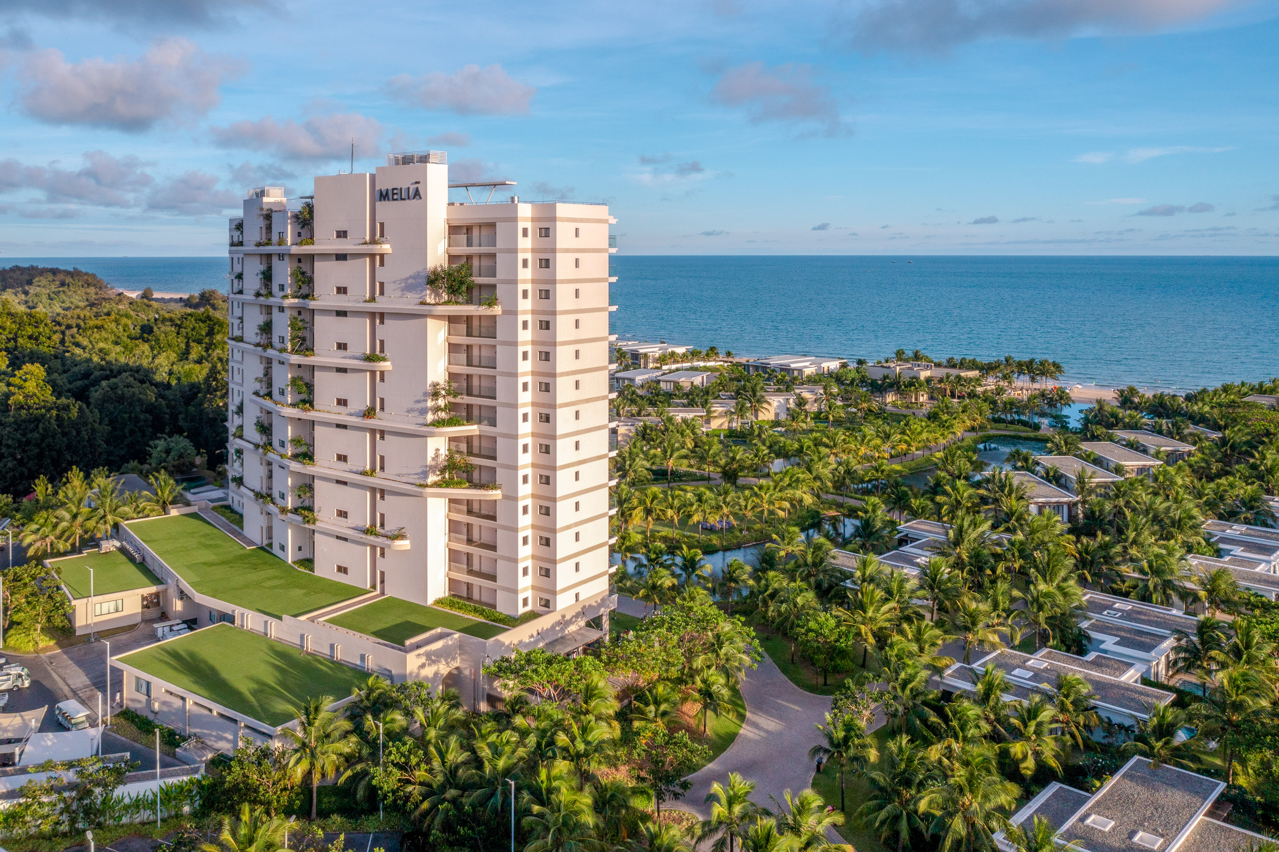 Aerial view of Meliã beachfront resort, ocean, tropical palms, and luxury villas.