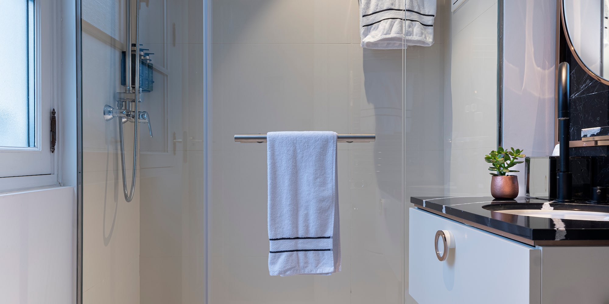 a bathroom with a glass shower door