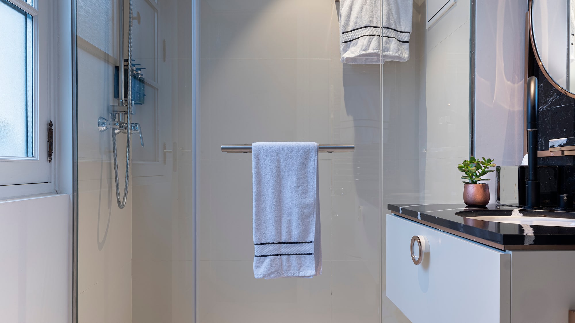 a bathroom with a glass shower door