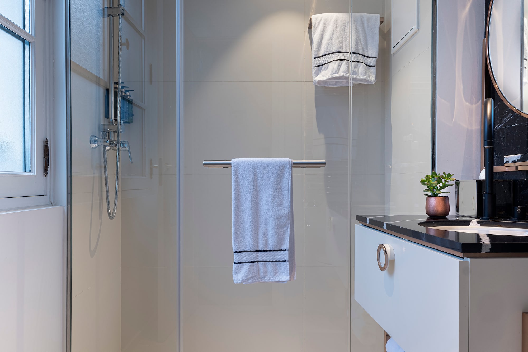 a bathroom with a glass shower door