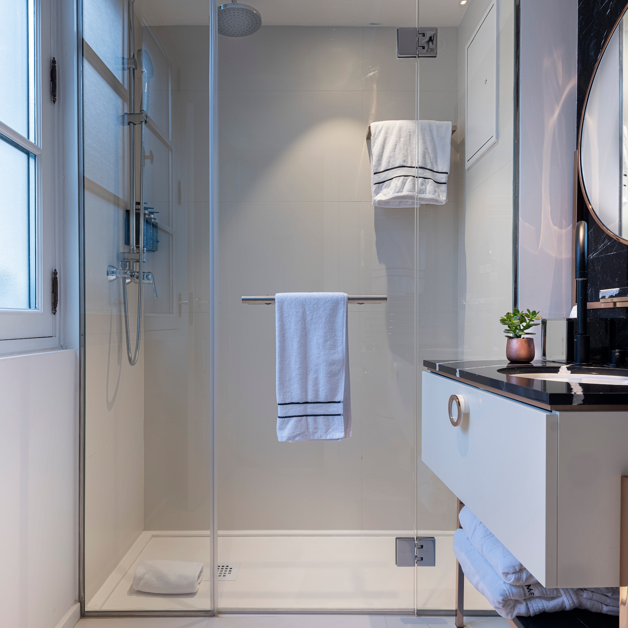 a bathroom with a glass shower door
