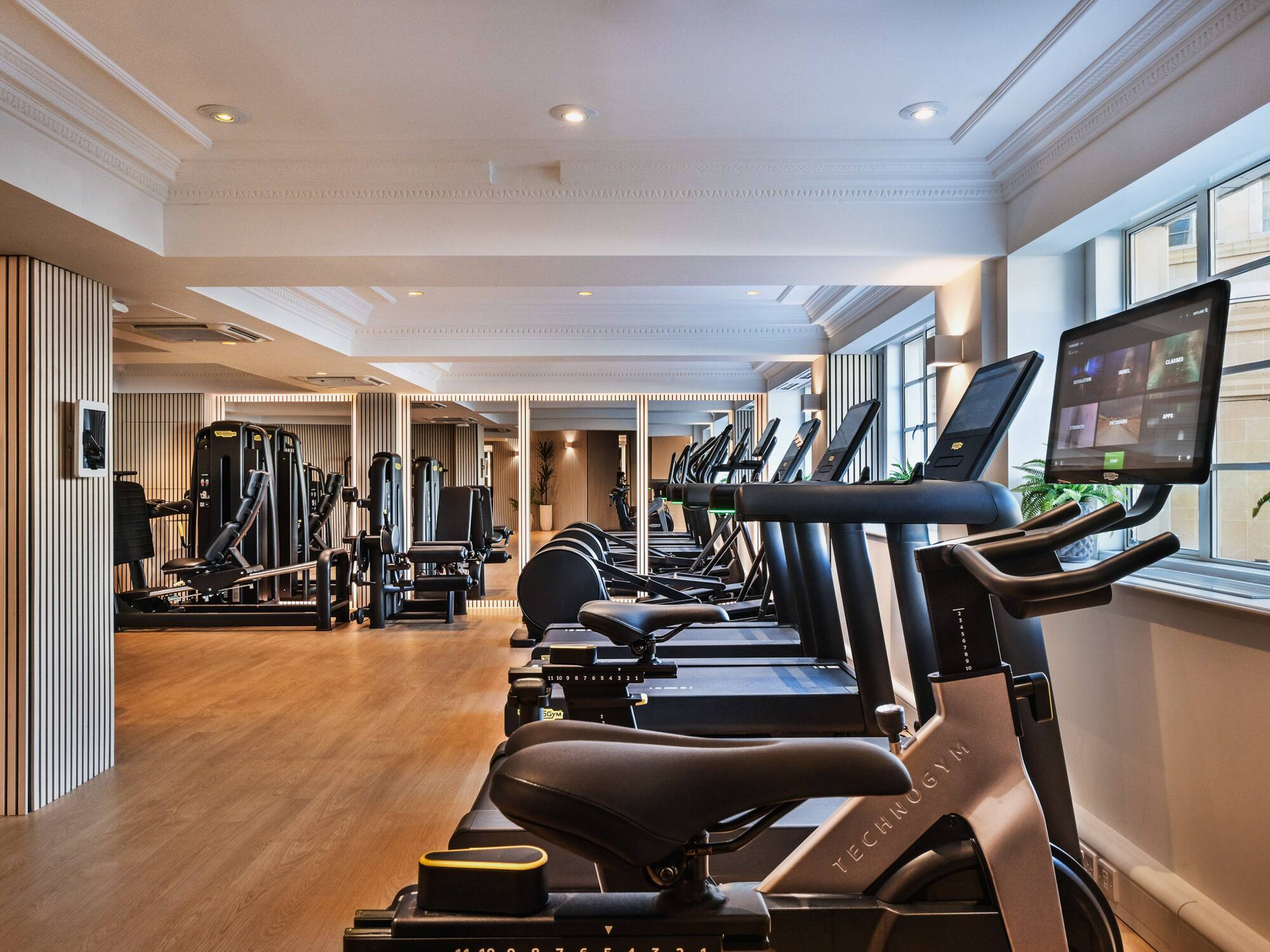 a room with exercise machines and a large window