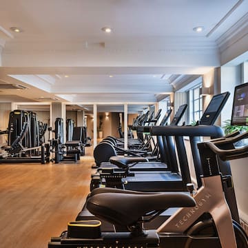 a room with exercise machines and a large window