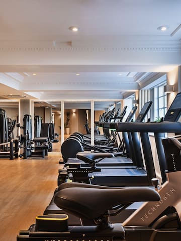 a room with exercise machines and a large window