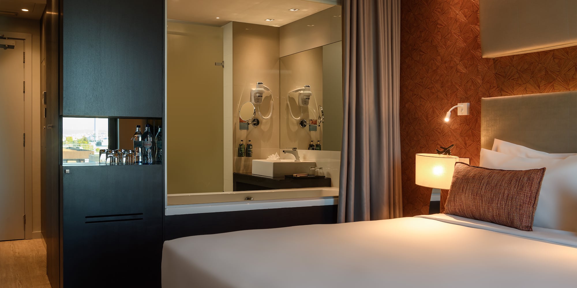 a bed with a mirror in the background