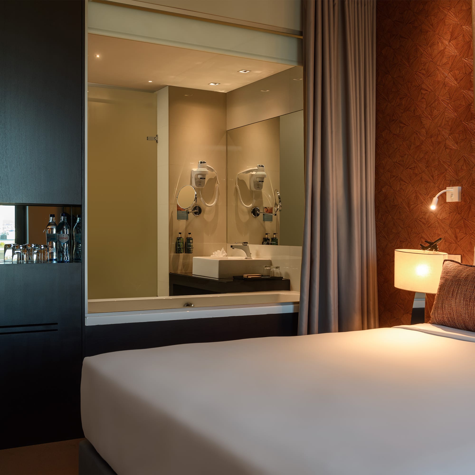 a bed with a mirror in the background