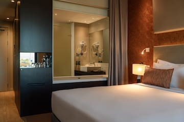 a bed with a mirror in the background