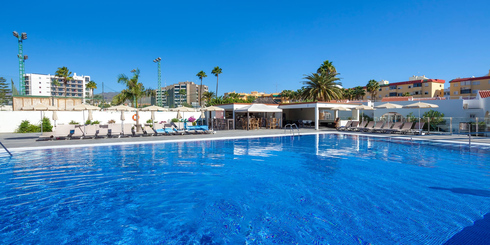 a pool with chairs and umbrellas