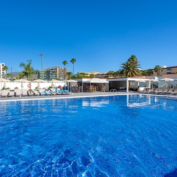 a pool with chairs and umbrellas