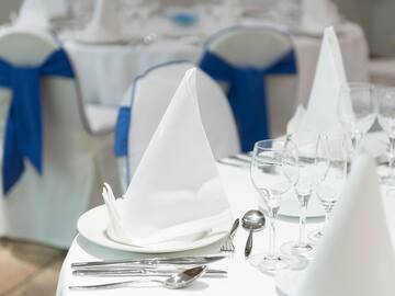 a table with white napkins and glasses