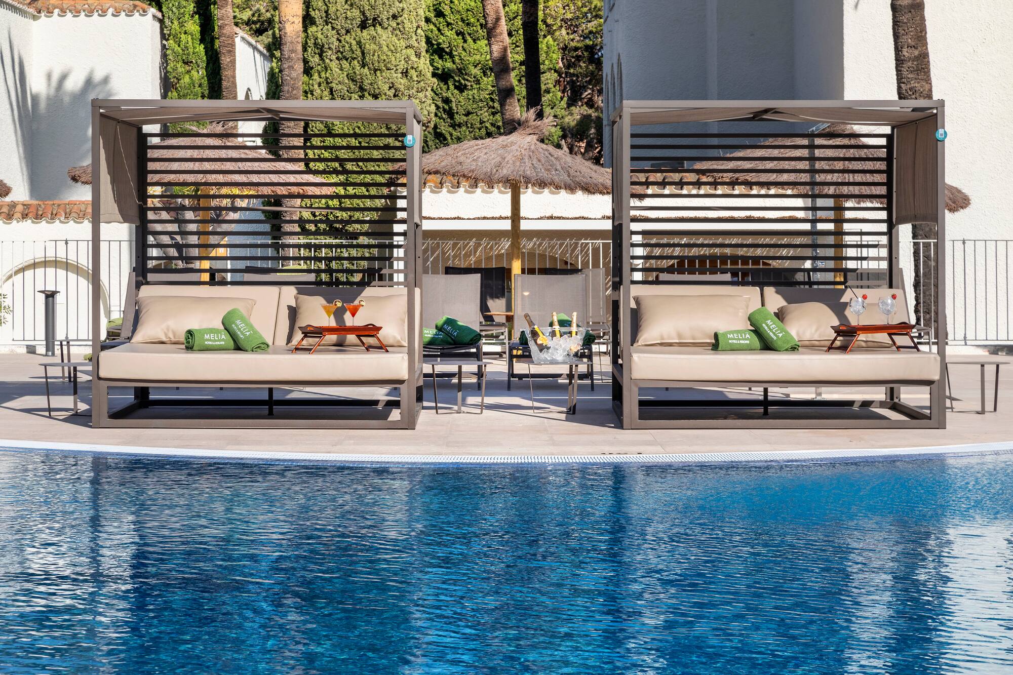 a pool with a lounge chair and a table