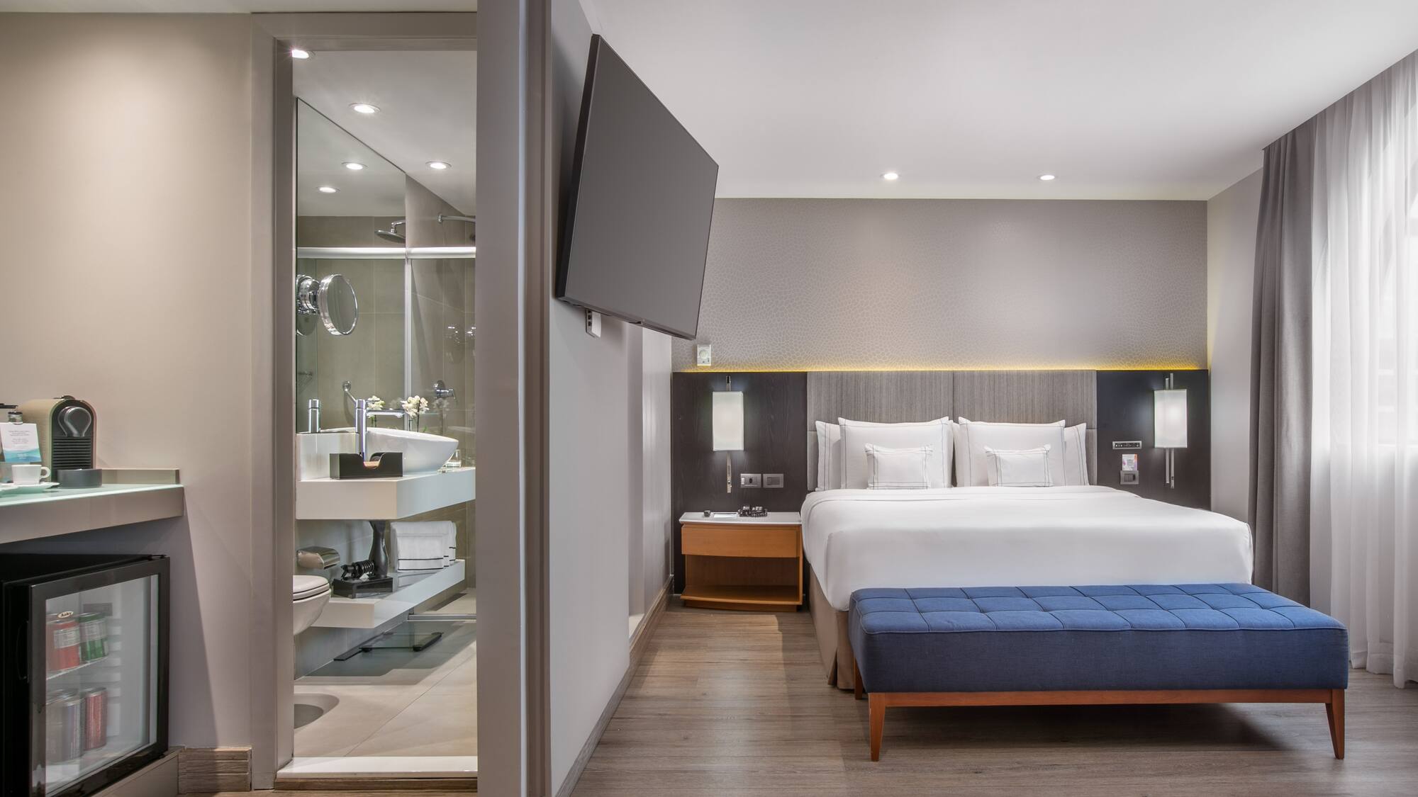 a room with a bed and a tv