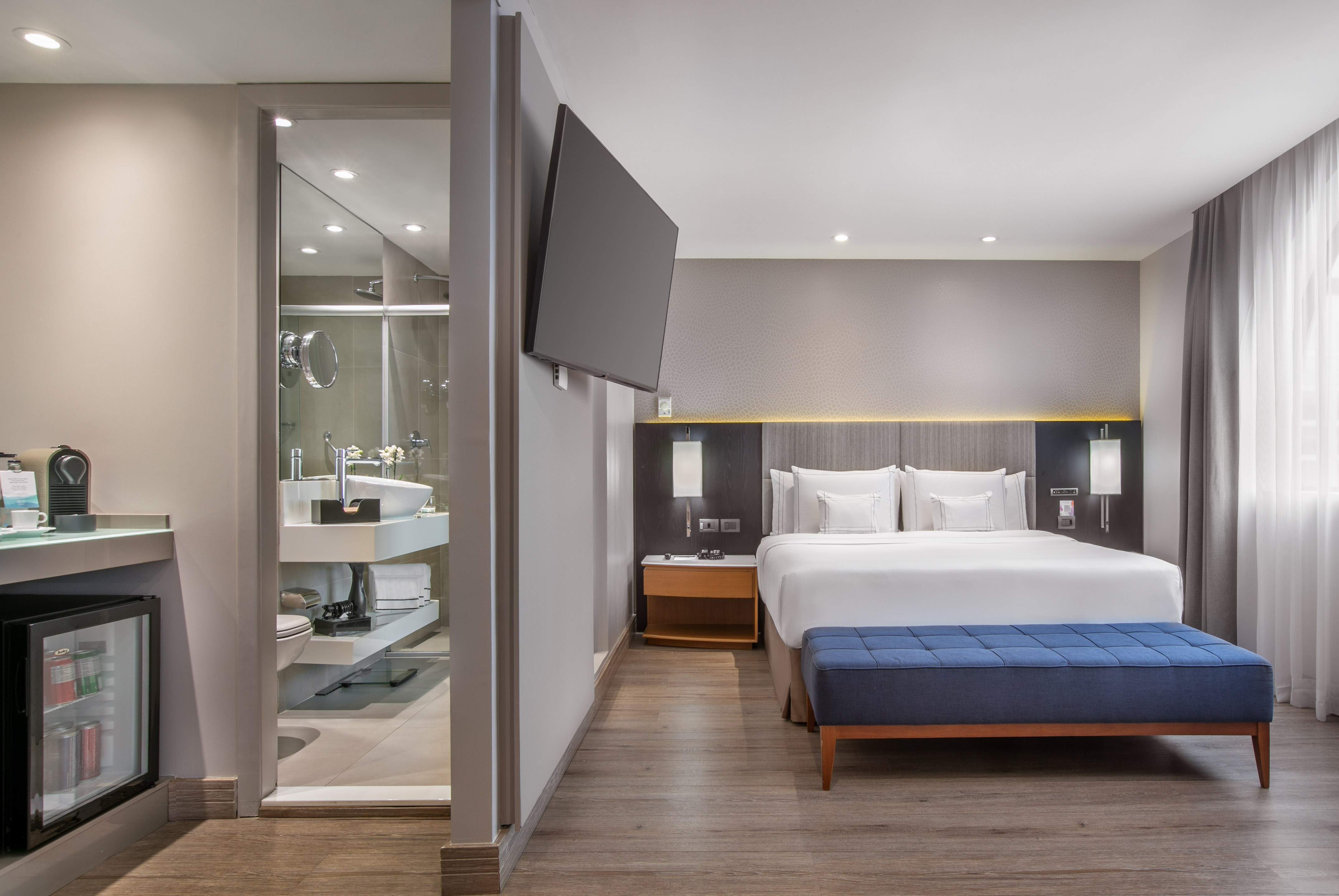 a room with a bed and a tv