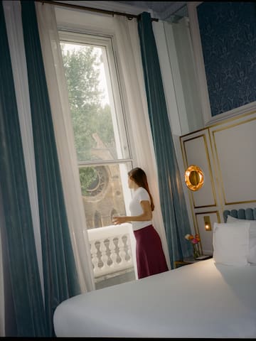 a woman standing in front of a window