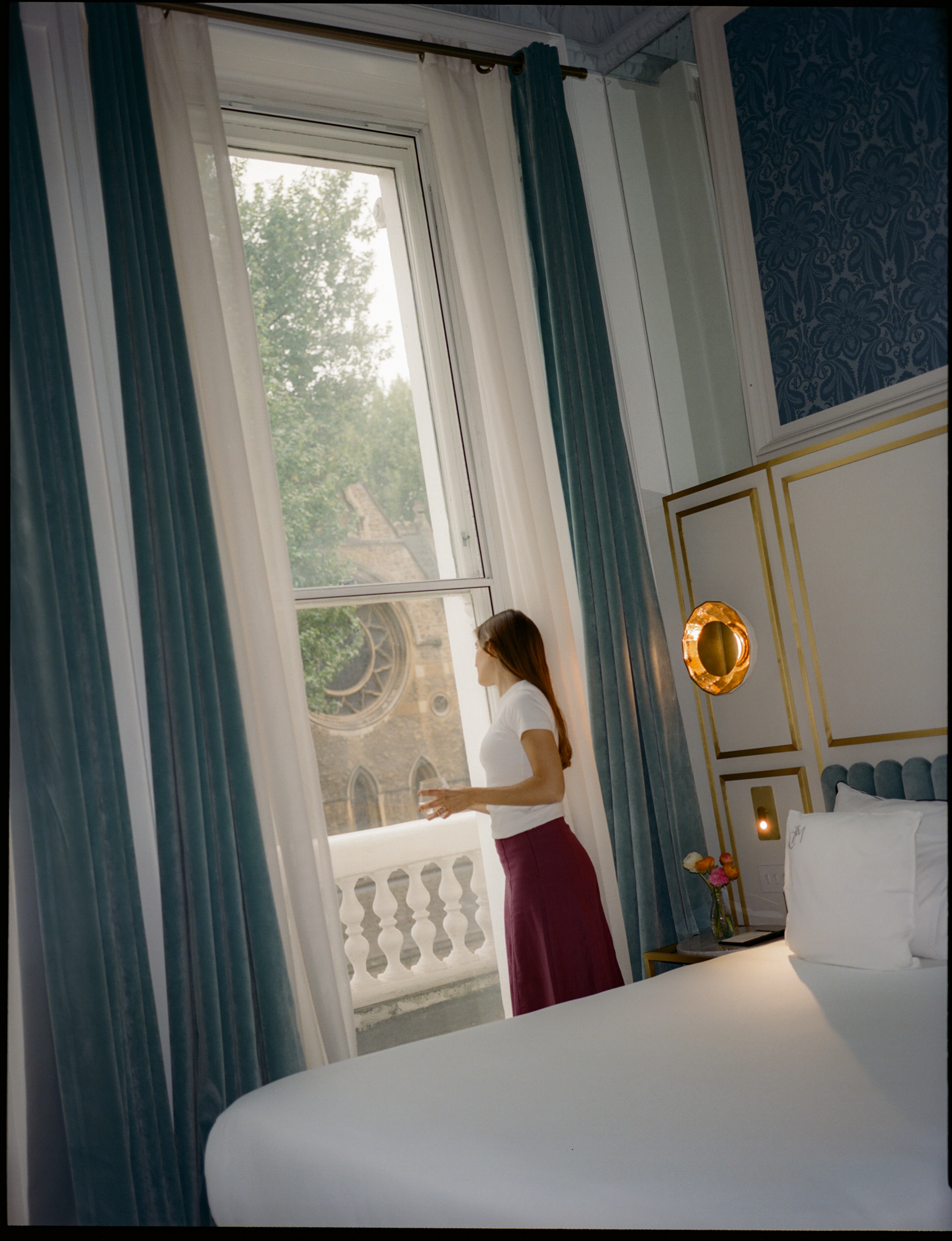 a woman standing in front of a window