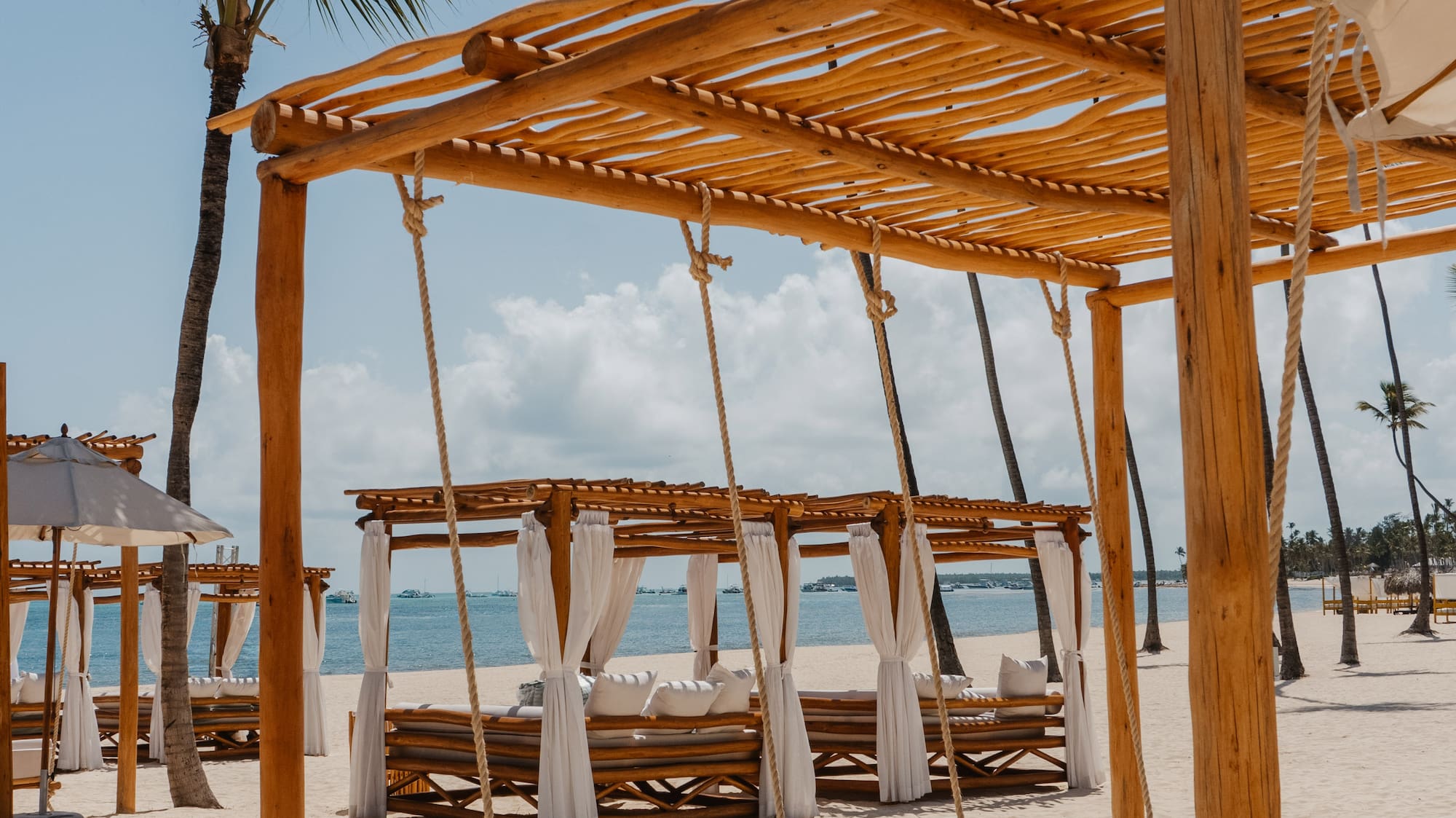 a beach with a canopy and a bed
