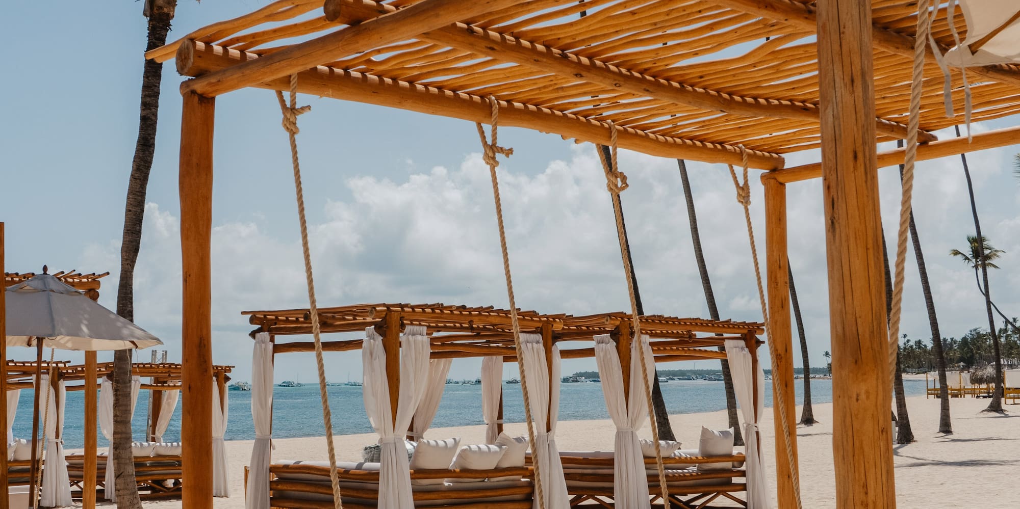 a beach with a canopy and a bed