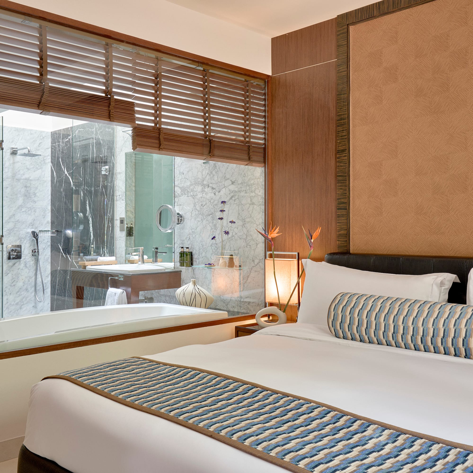 a bed in a room with a bathtub and window