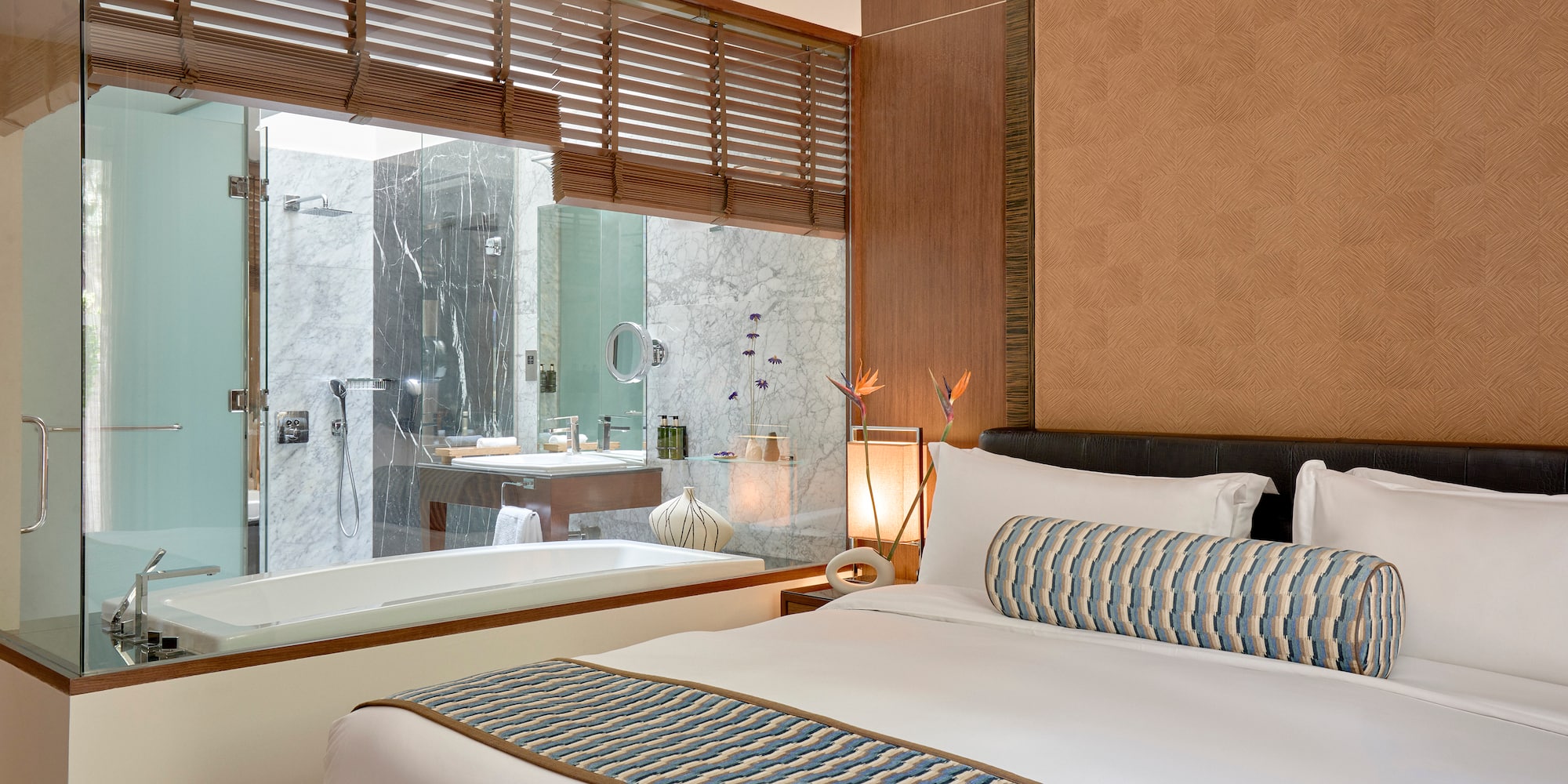 a bed in a room with a bathtub and window