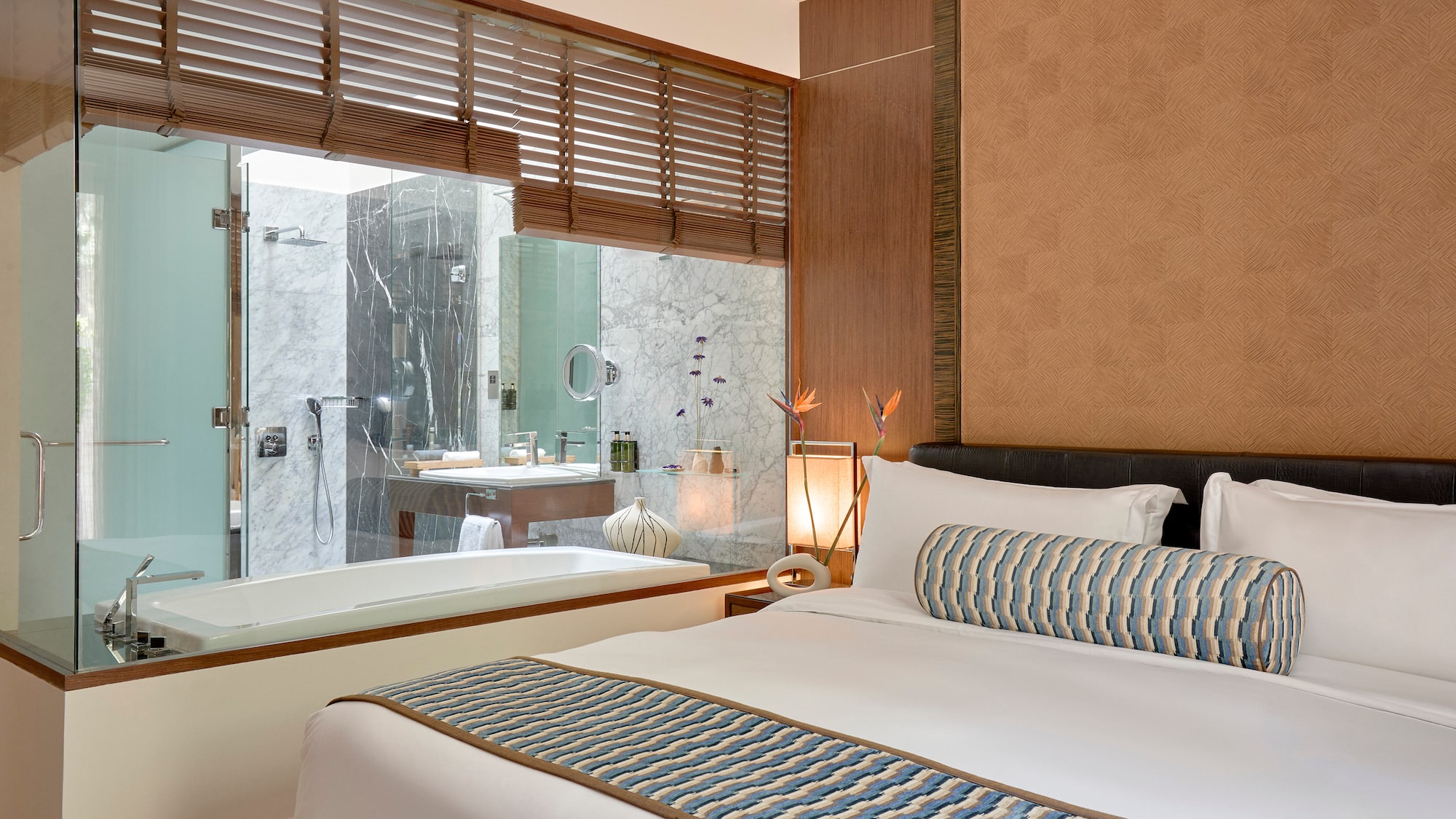 a bed in a room with a bathtub and window