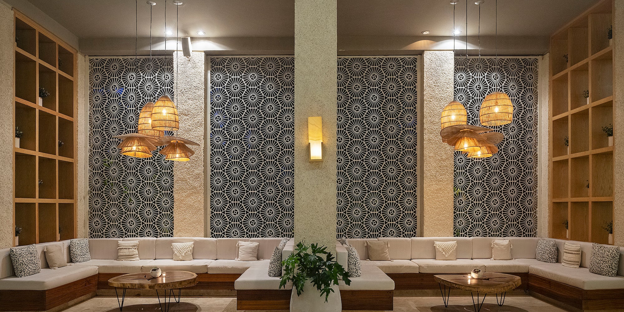 a room with a large white couch and a plant