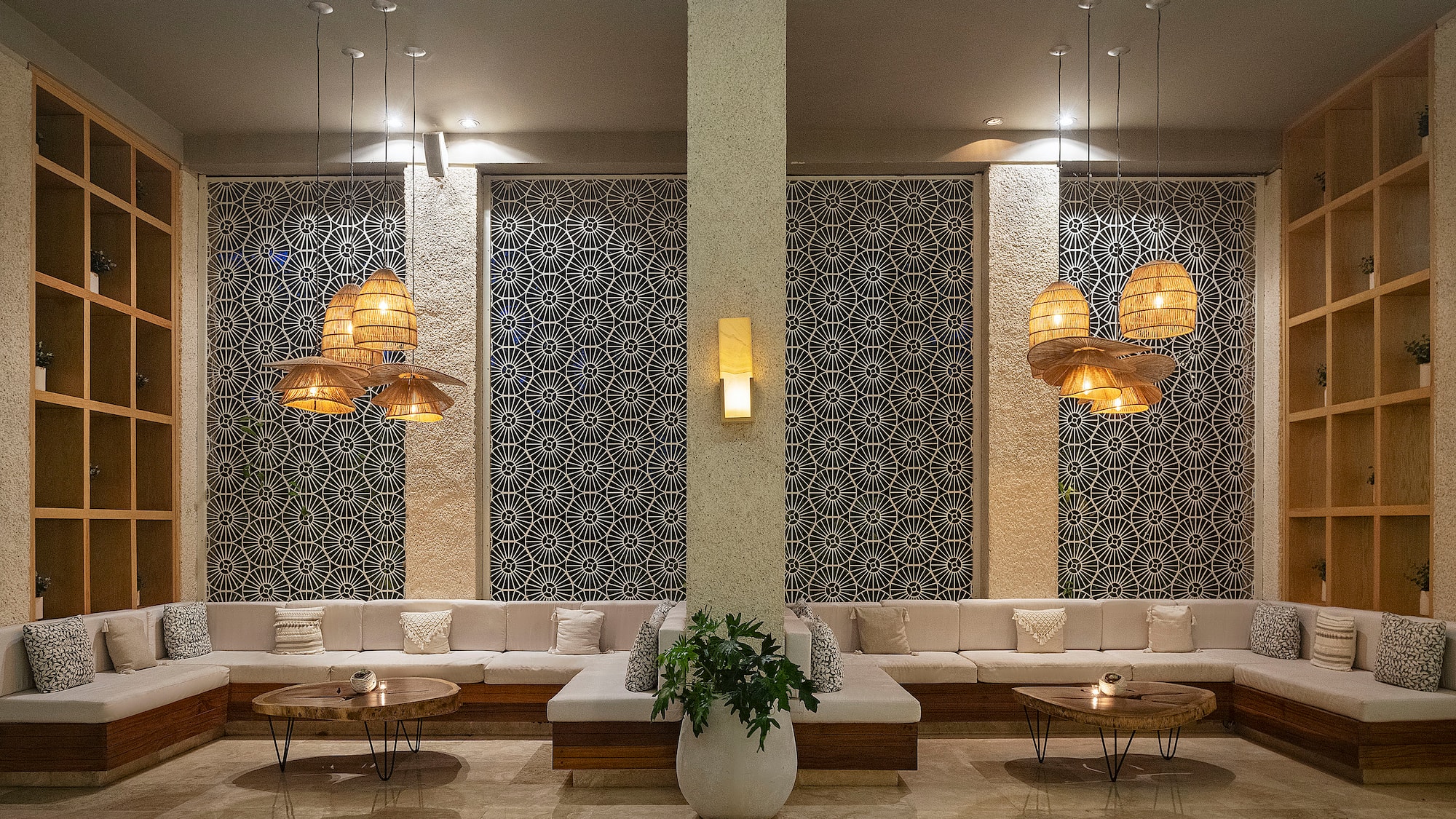 a room with a large white couch and a plant