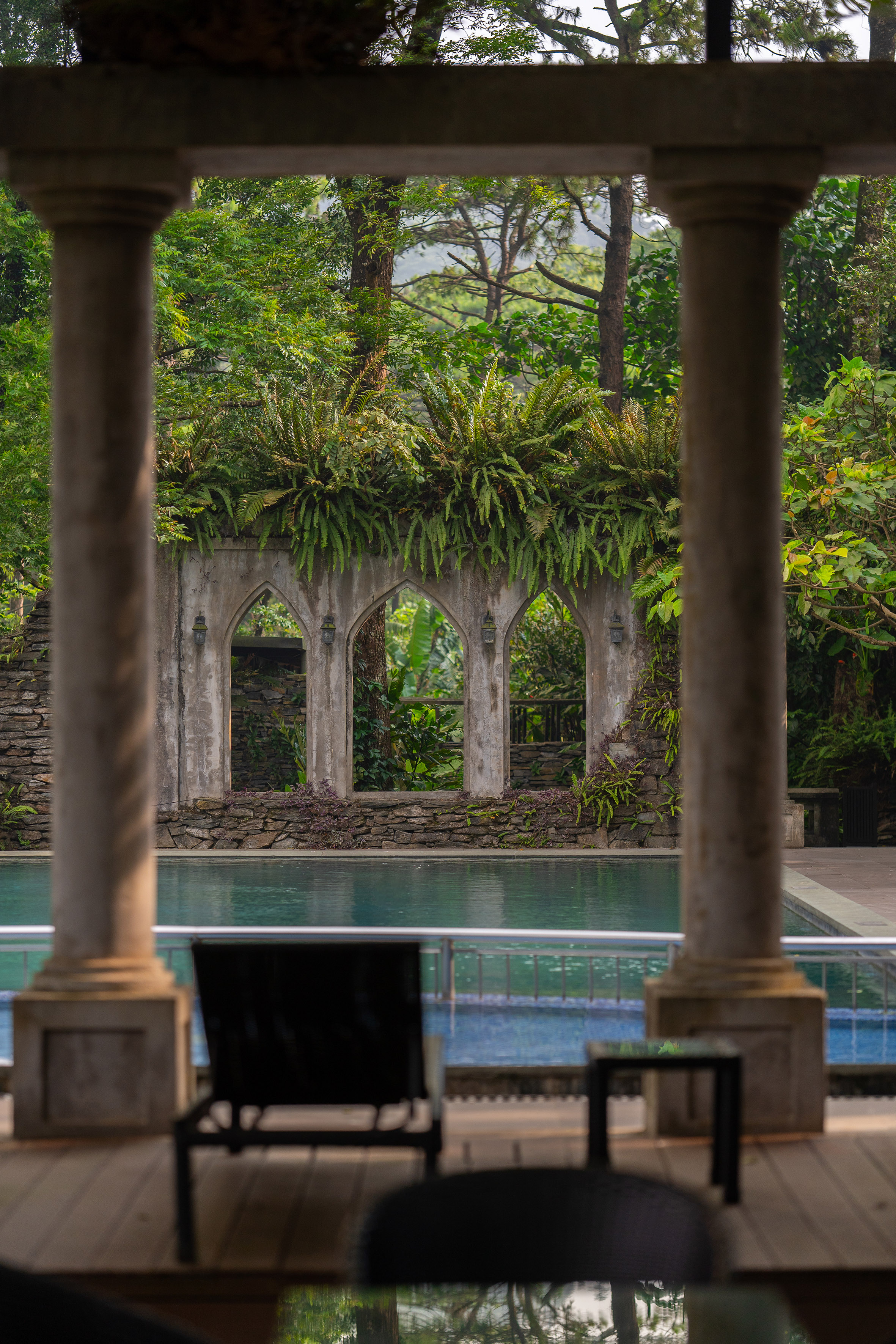 a pool with a stone wall and a stone wall with a stone wall and a stone wall with a stone wall and a stone wall with a stone wall with a stone wall and a stone wall with