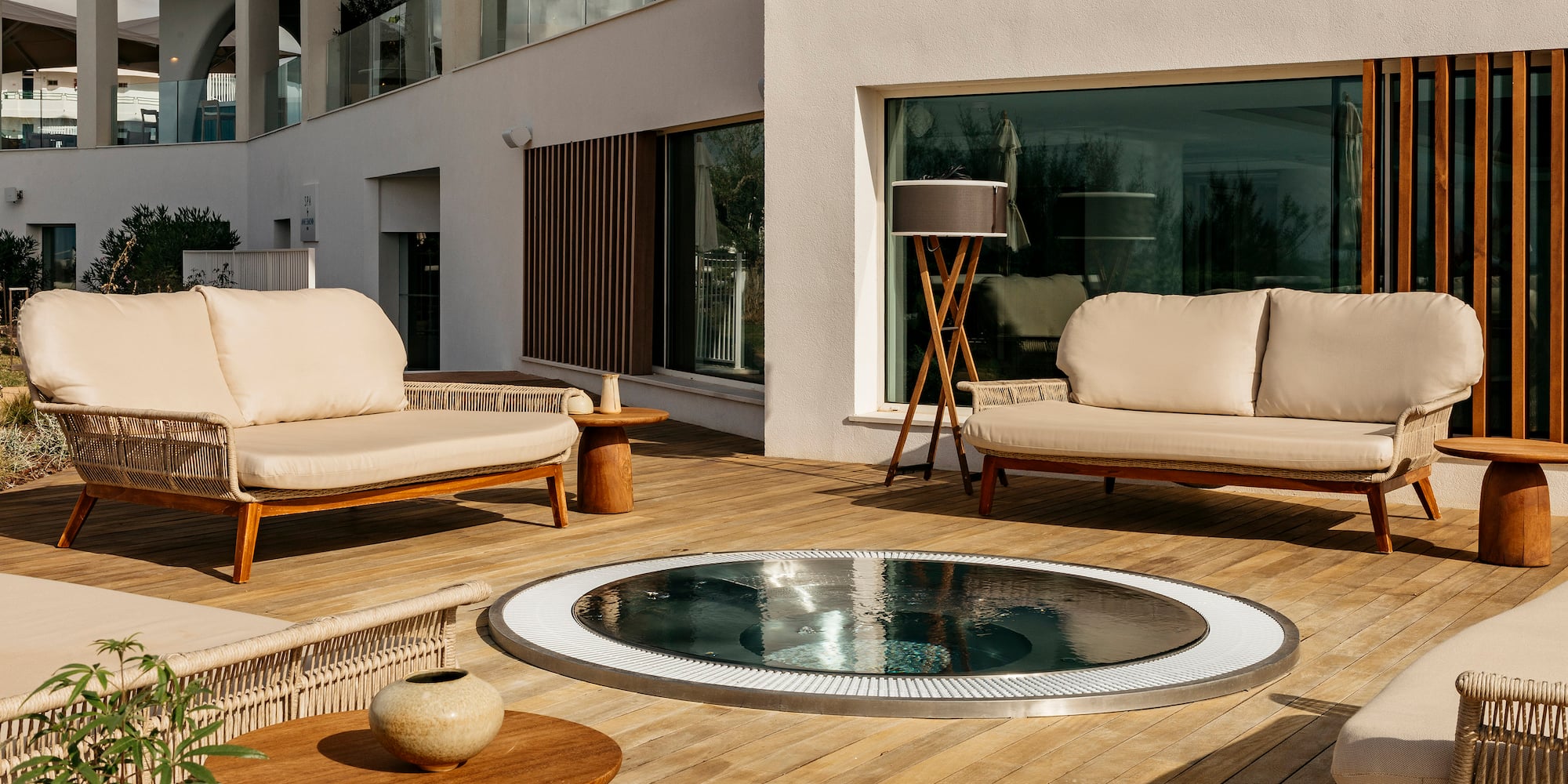 a patio with a hot tub and couches