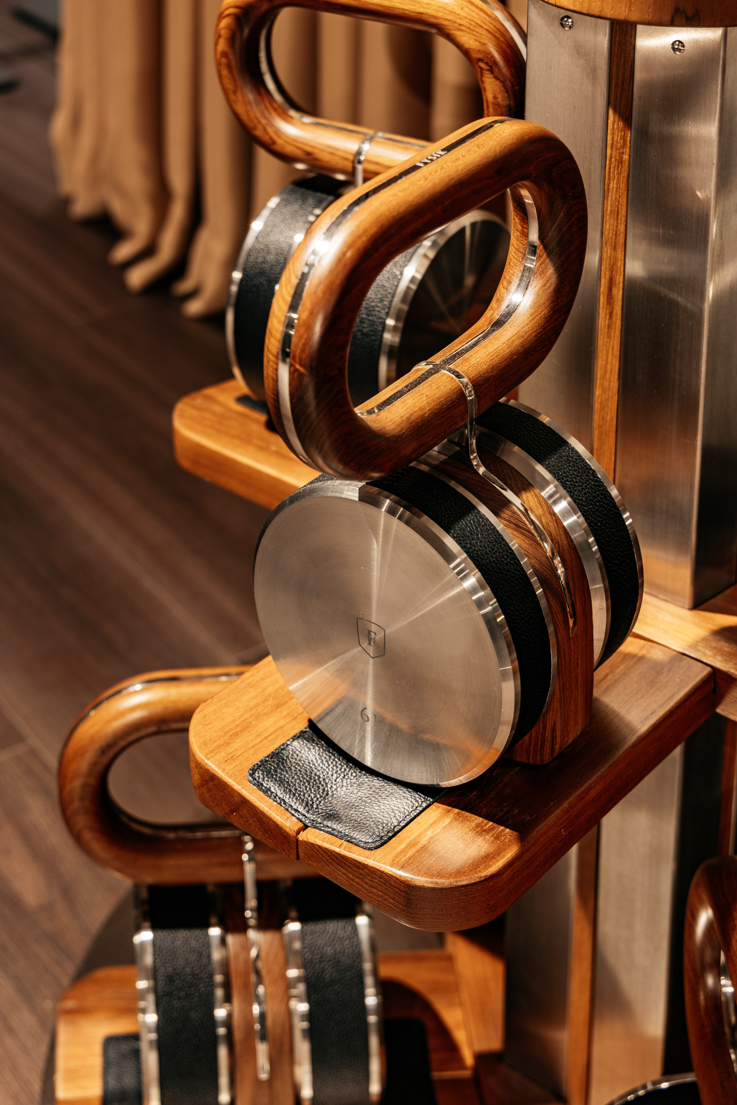 Luxury wooden and metal headphones with leather on display.