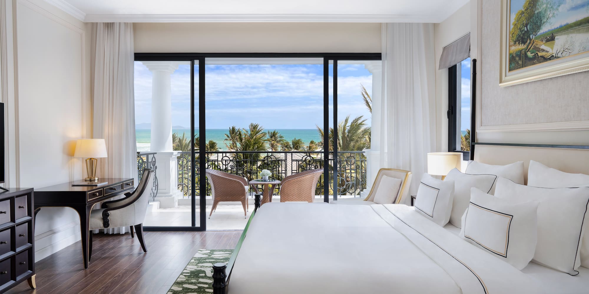 a bedroom with a balcony overlooking the ocean