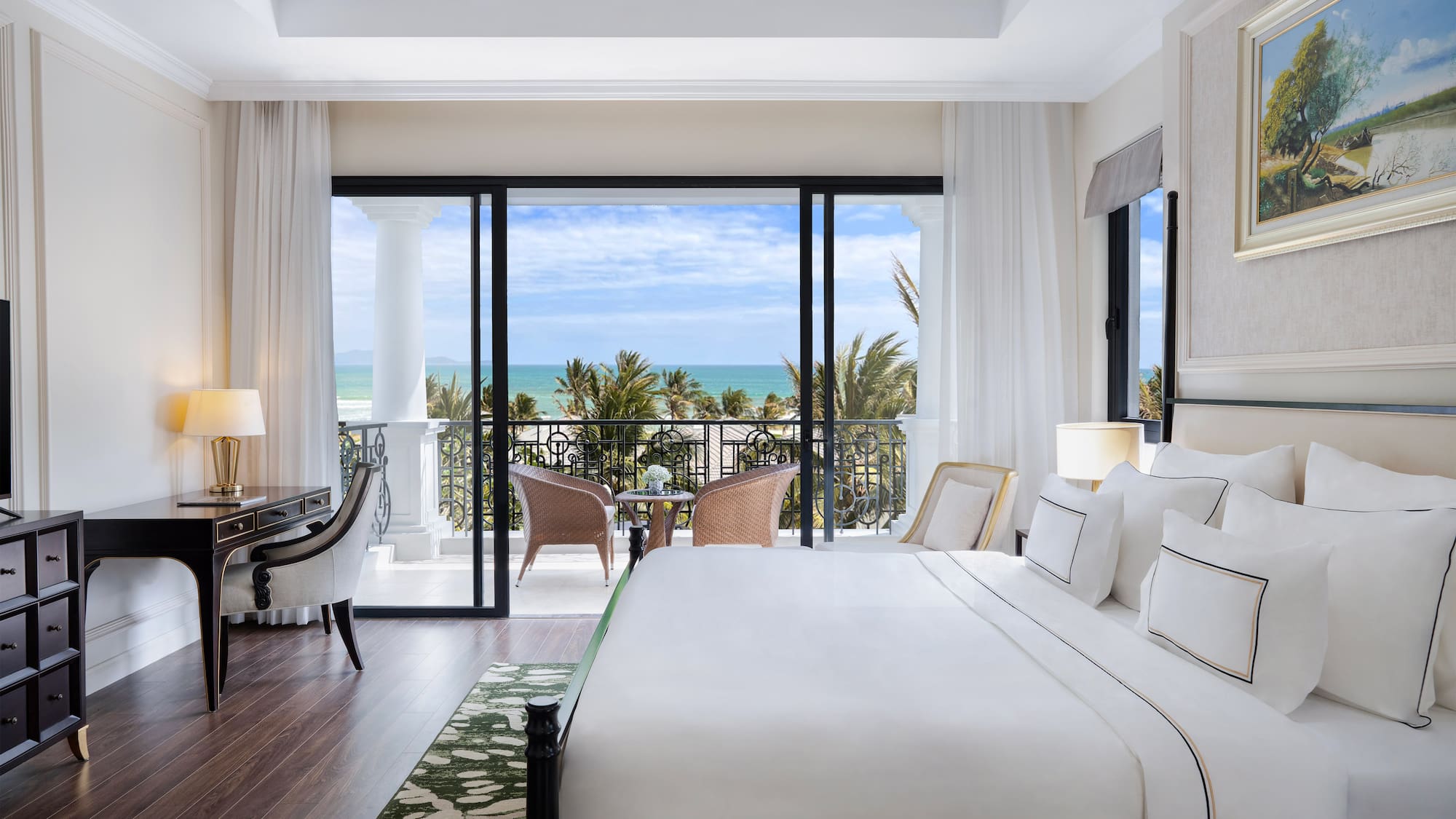 a bedroom with a balcony overlooking the ocean