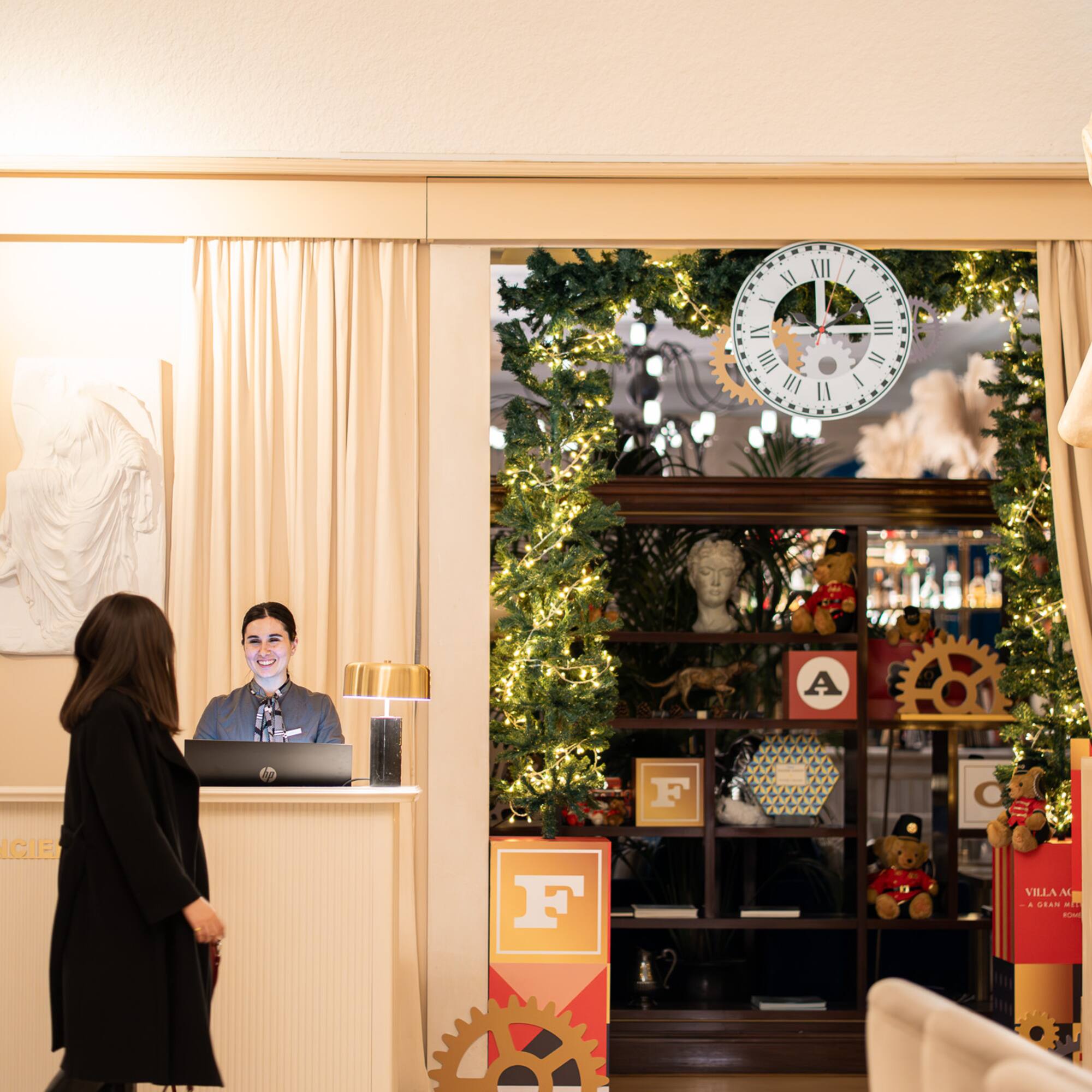 a woman standing in front of a reception desk