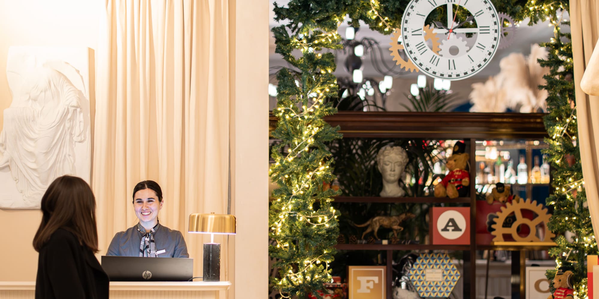 a woman standing in front of a reception desk