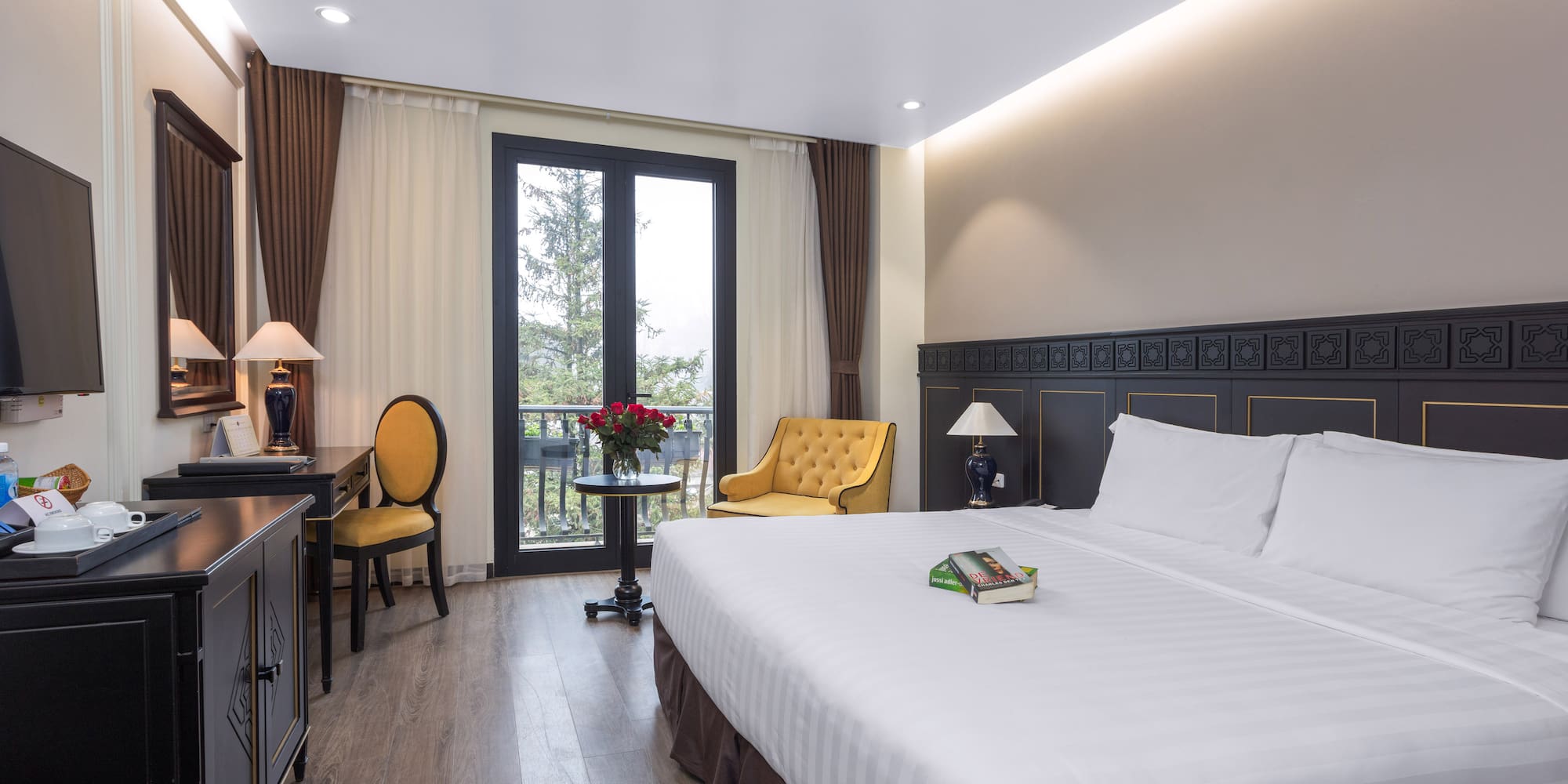 a room with a bed and a table and chairs