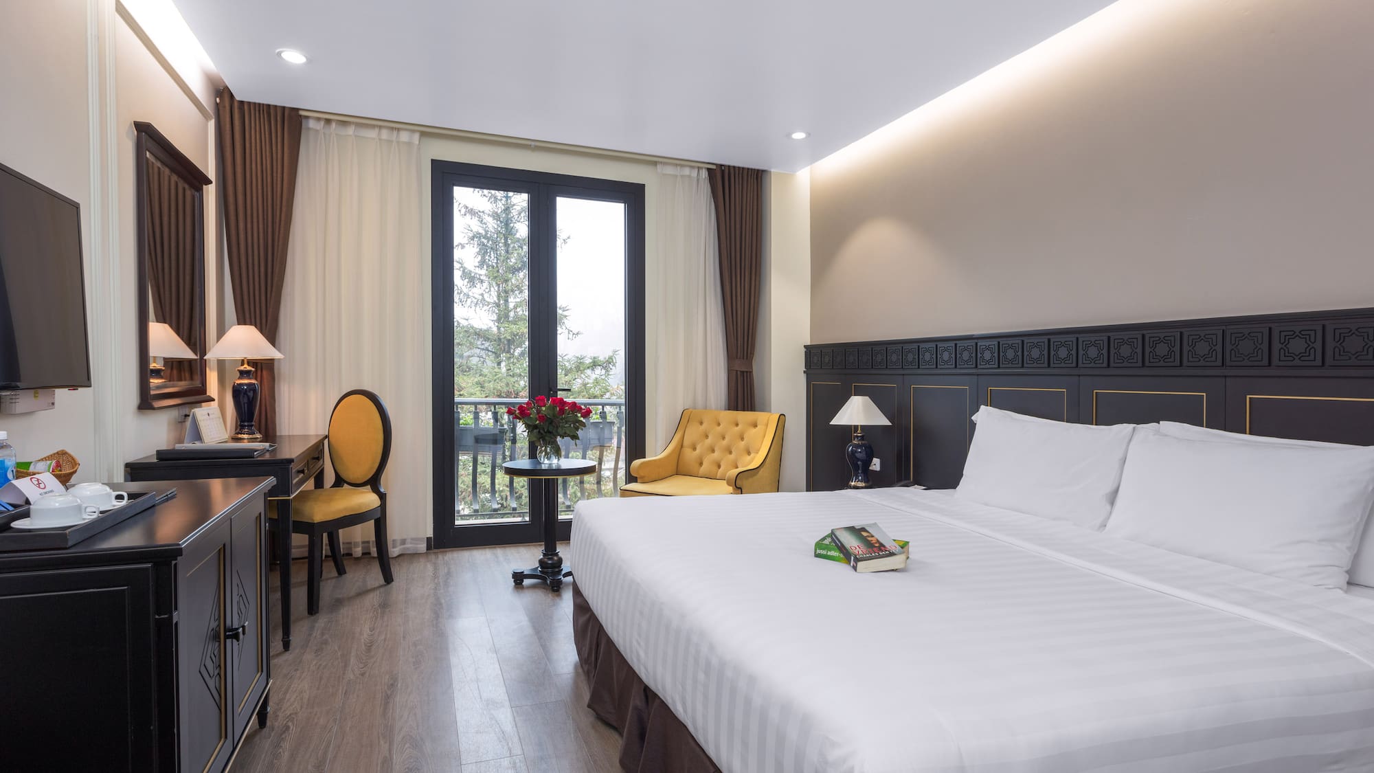 a room with a bed and a table and chairs