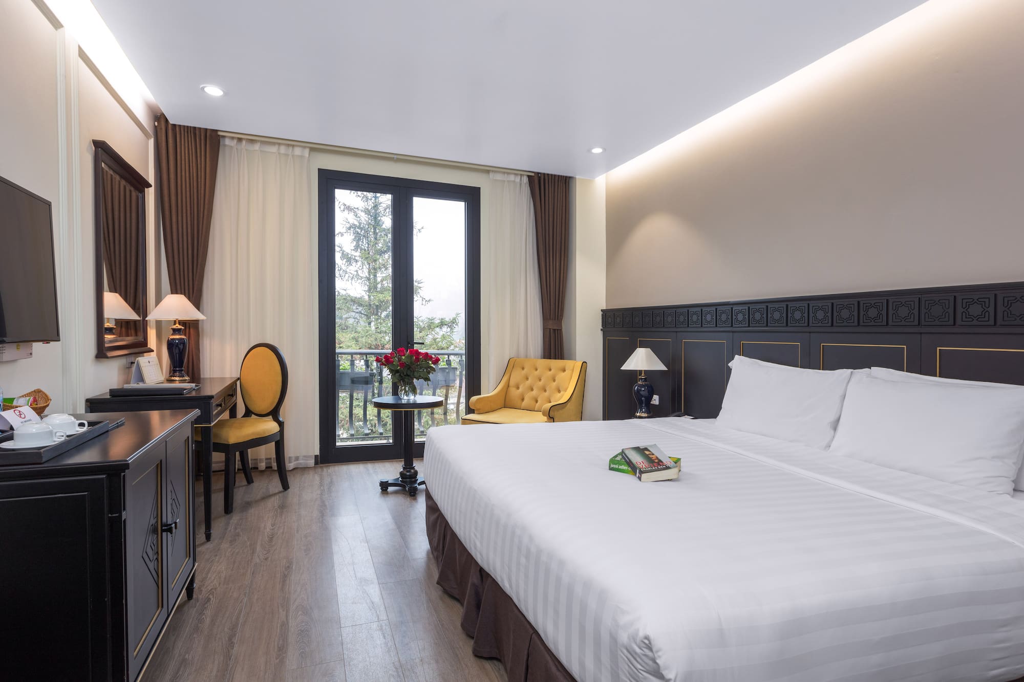 a room with a bed and a table and chairs