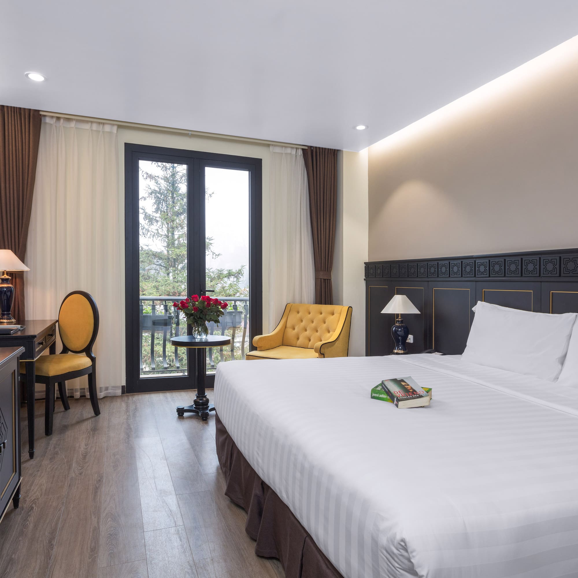 a room with a bed and a table and chairs